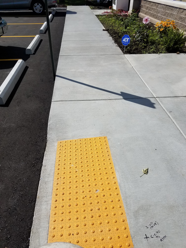 A sidewalk grip plate installed in front of a Wisconsin Business
