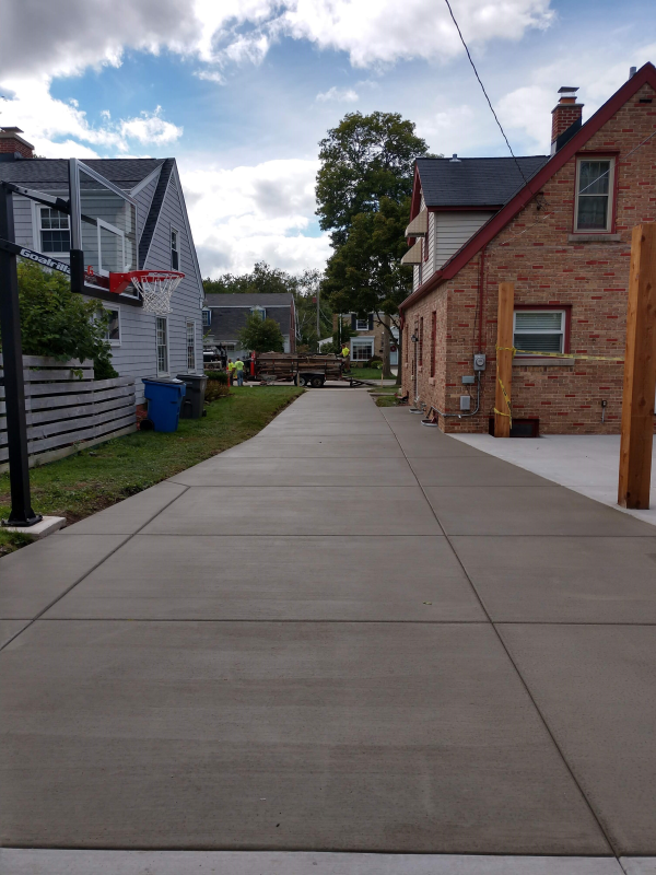 A custom driveway installation with access to window wells