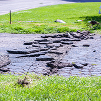 cracking asphalt driveway needing a conversion