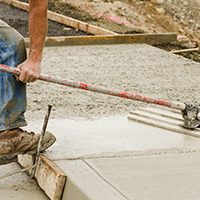 replacement driveway concrete being smoothed