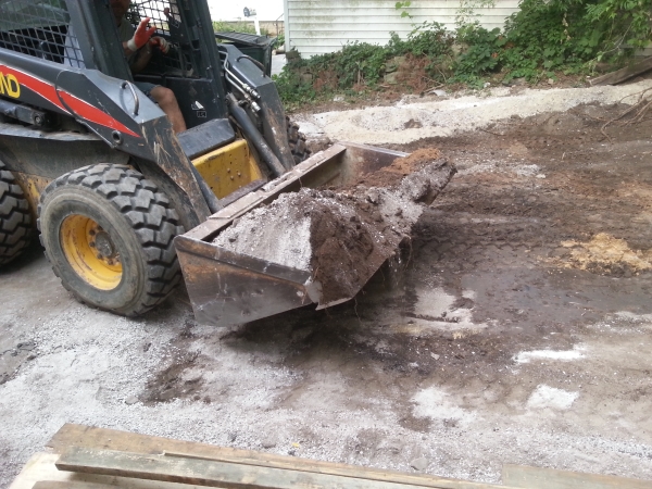 Front loader prepping for garage slab